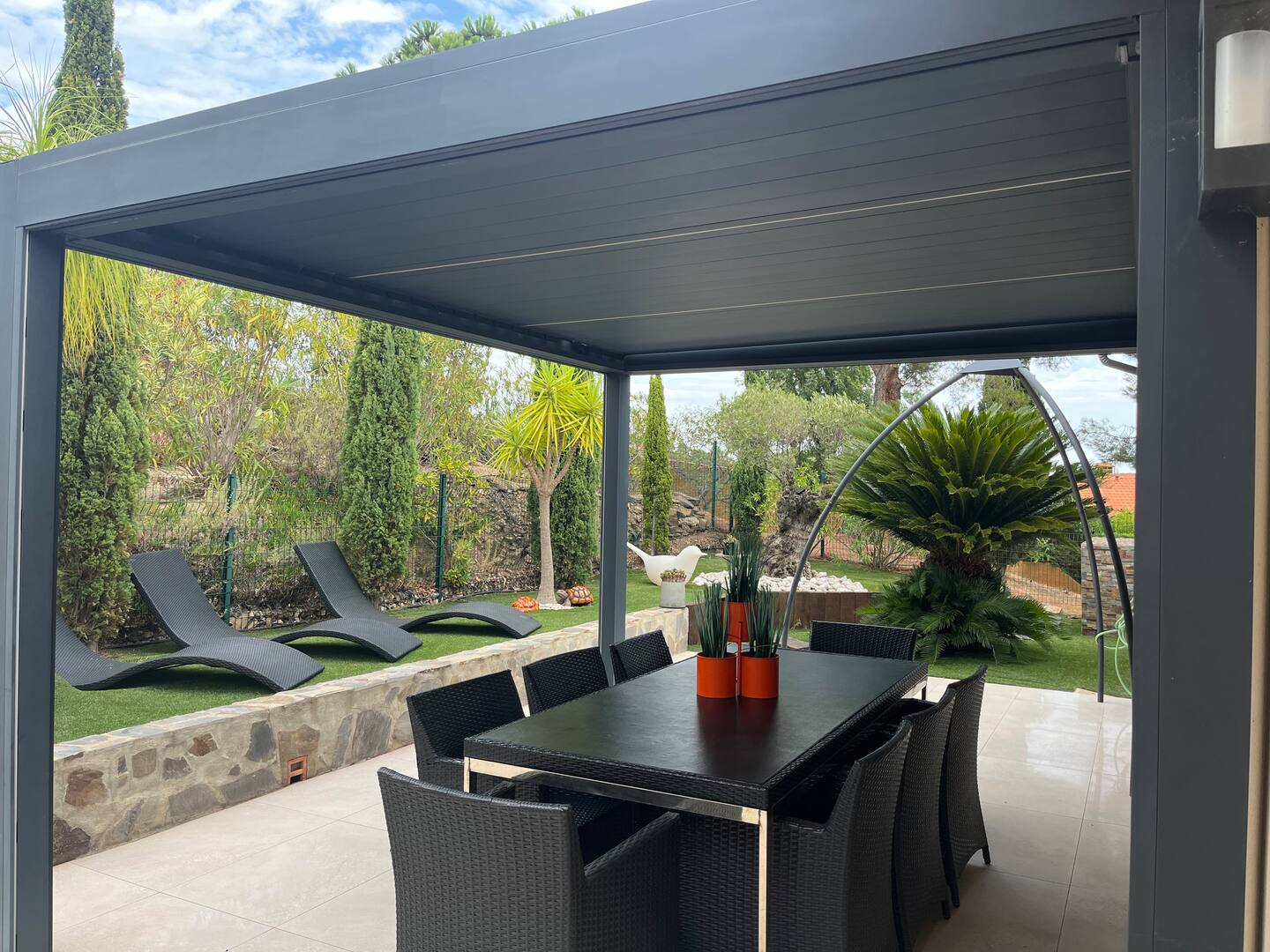 Pergola dining area opening onto the landscaped garden